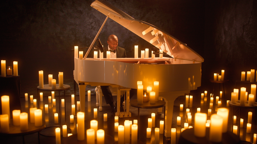 A cinematic candlelit performance shot in studio